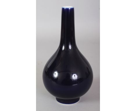 A CHINESE BLUE GLAZED PORCELAIN BOTTLE VASE, the base with a Qianlong seal mark, 7in high.