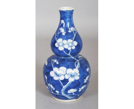A 19TH CENTURY CHINESE BLUE & WHITE DOUBLE GOURD PORCELAIN PRUNUS VASE, the base with a four-character Kangxi mark, 6.2in hig