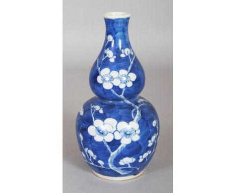 A 19TH CENTURY CHINESE BLUE & WHITE DOUBLE GOURD PORCELAIN PRUNUS VASE, the base with a four-character Kangxi mark, 6.2in hig