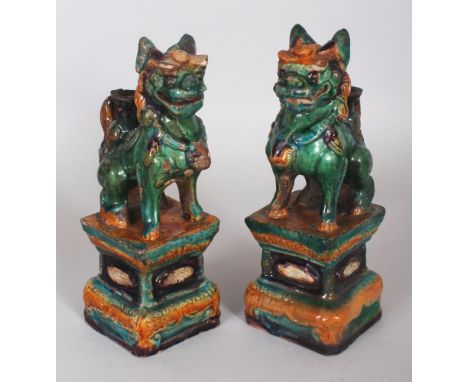 A PAIR OF CHINESE MING DYNASTY FAHUA GLAZED POTTERY BUDDHISTIC LION JOSS STICK HOLDERS, 7.8in high.