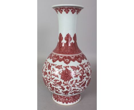 A CHINESE MING STYLE COPPER RED PORCELAIN LOTUS SCROLL PORCELAIN VASE, the base with a Qianlong seal mark, 12.8in high.