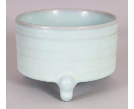 A CHINESE JUN WARE PORCELAIN TRIPOD CENSER, with rib moulded sides, 5.3in diameter at rim & 3.75in high.