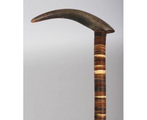 ANOTHER HORN WALKING STICK, possibly partially rhinoceros horn, the shaft formed from graduated bands, 35.75in long, the hand