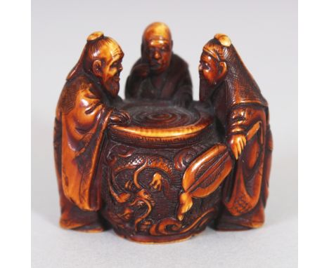 A GOOD QUALITY JAPANESE MEIJI PERIOD STAINED IVORY NETSUKE BY GYOKUZAN, carved in the form of three sages peering into a drag