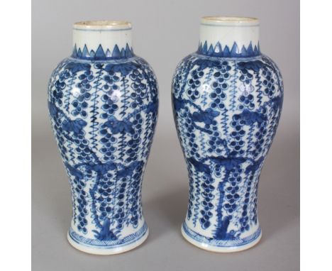 A PAIR OF CHINESE KANGXI PERIOD BLUE & WHITE SQUIRREL & VINE PORCELAIN VASES, circa 1700, 8.75in high.