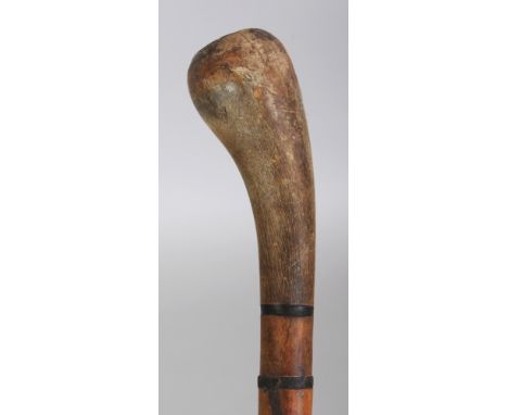 A HORN WALKING STICK, possibly partially rhinoceros horn, the shaft formed from graduated cylindrical segments, the handle in