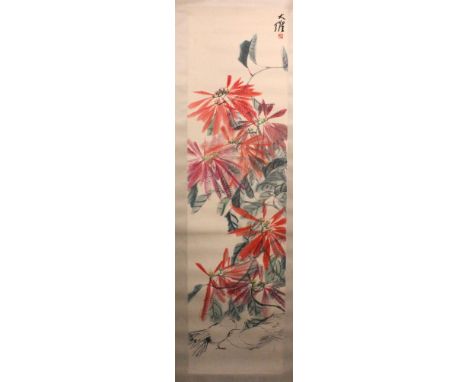 A SIGNED CHINESE SCROLL PAINTING ON PAPER, depicting flowering shrubs, the painting itself approx. 58.5in x 15.6in.