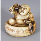 A GOOD SIGNED JAPANESE MEIJI PERIOD IVORY NETSUKE OF HOTEI, washing himself in an oval tub, the base