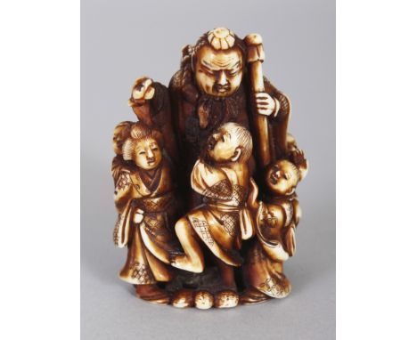 A GOOD QUALITY SIGNED JAPANESE MEIJI PERIOD STAINED IVORY NETSUKE, carved in the form of a standing man in the company of a b