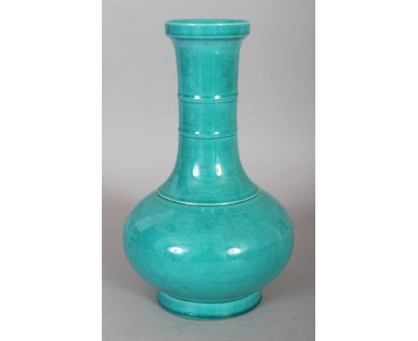 A CHINESE TURQUOISE GLAZED PORCELAIN BOTTLE VASE, with a ribbed neck, the base with a six-character Kangxi mark, 8.8in high.