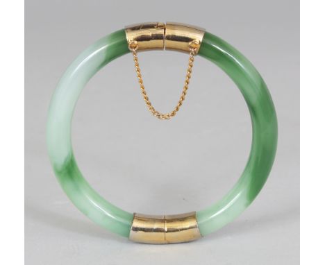 A CHINESE CELADON & DARK GREEN JADE-LIKE GLASS BANGLE, opening on a hinge with gilt metal fittings and clasp, 2.9in diameter,