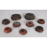 A SMALL COLLECTION OF NINE JAPANESE WOOD VASE STANDS, the largest 3.5in diameter. (9)