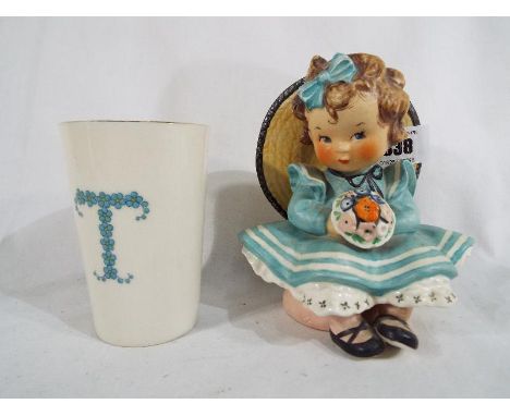 W Goebel - a figurine depicting a young girl with posy, Goebel Charlot Byj Sitting Pretty, 13.5 cm (high)  and a beaker by W 