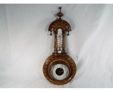 An early 20th century aneroid wheel barometer with thermometer in carved case, 40 cm (high) - Est £30 - £50