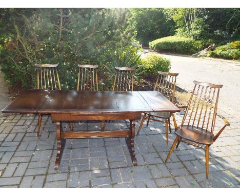 Ercol - a Goldsmith high stick back carver chair, four dining chairs and an extending dining table