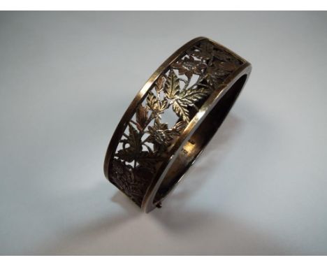 A Victorian bangle with fancy pierced 9 carat front, Estimate £25 - £40