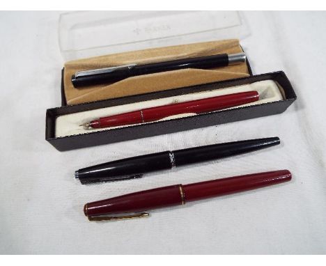 A red Parker '17' fountain pen, a black Parker UII pen, a further black Parker pen and a one other
