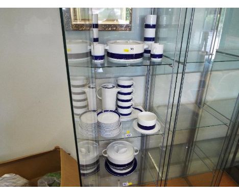 A collection of approx 38 pieces of Thomas of Germany ceramic white tableware decorated with a blue band, (three shelves)