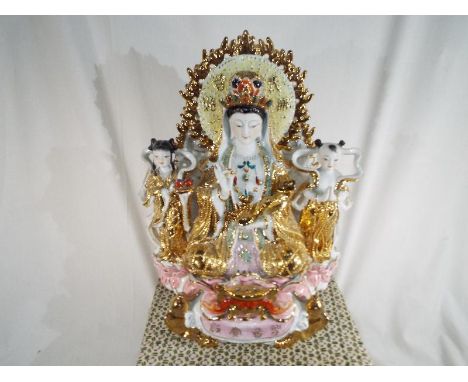 A ceramic statue in the form of Gwan Jin Goddess in a protective box 42 cm x 30 cm