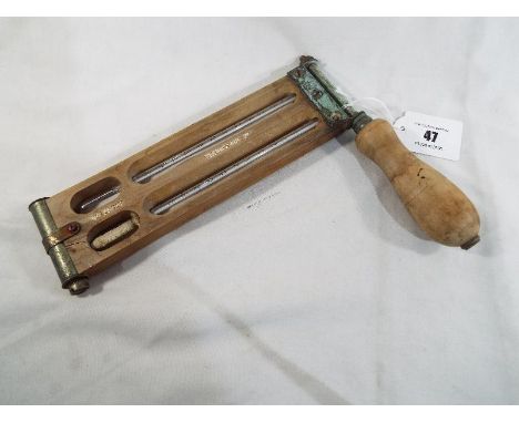A twin-thermometer in rotating hand-held holder by Short & Mason of London, the wooden holder marked Thermotank Ltd, No 123/1