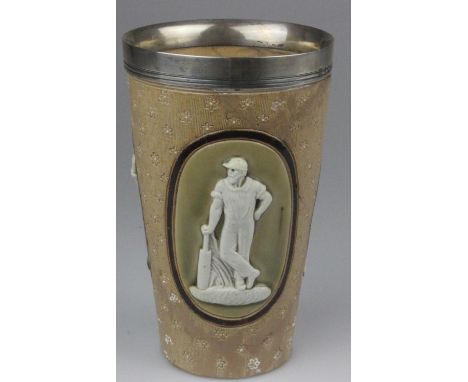 A Royal Doulton Lambeth Ware cricket beaker with a silver rim. The three scenes are of cricketers in white relief on a light 