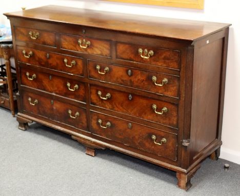 A George II mahogany mule chest, circa 1750, the moulded oblong top above five dummy drawers and two sets of two real drawers