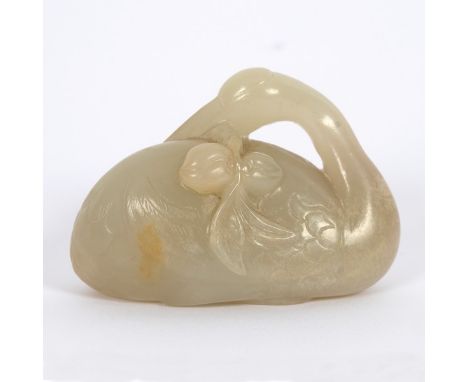 An 18th Century Chinese pale celadon jade and russet crane, carved with its head along its back clutching a peach branch, 5.7