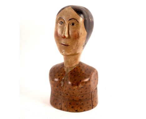 An early 19th Century milliner's mannequin, the carved pine and painted head and shoulders of a woman with black centrally pa