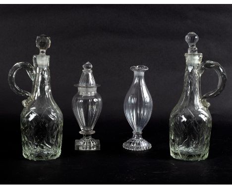 Two early 19th Century oil or condiment bottles, the bodies of bulbous form with lemon squeezer bases, 16cm and 17.5cm and a 