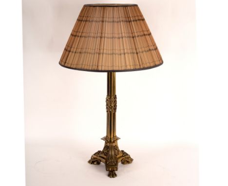 A gilt brass table lamp of column form, on paw feet, 64cm high excluding shade