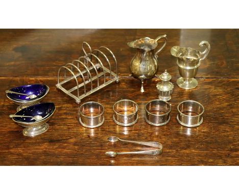 A pair of open silver salts, Chester 1894, with blue glass liners, two jugs, four napkin rings, etc., gross weight approximat