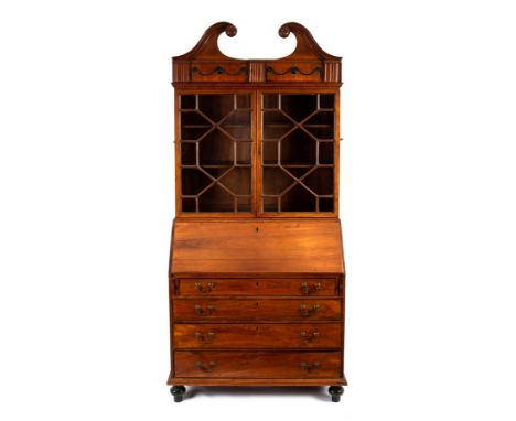 An Anglo-Chinese rosewood bureau bookcase, probably Canton, 19th Century, the moulded swan neck pediment above a moulded frie