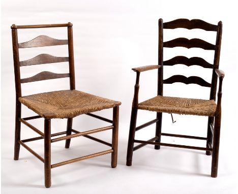 An 18th Century ash ladder back armchair with a rush seat, another similar and a Lancashire style side chair with a spindle b