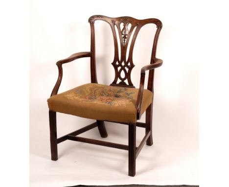 A George III mahogany armchair of Chippendale design with carved serpentine top rail and pierced vase shaped splat, leaf carv