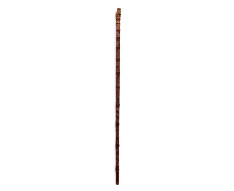 A Chinese walking stick, circa 1850, with dog of Fo finial and decorated with buildings and garden landscapes etc., 100cm lon