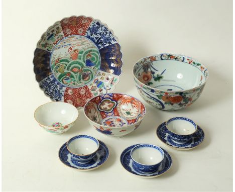 An Imari saucer dish with fluted rim, central decoration of waves and shells, 24cm diameter, two Imari bowls and other cerami