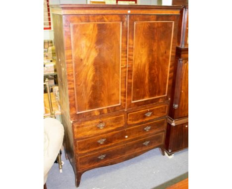 A George III mahogany linen press, circa 1800, the two panelled doors above two short and two long satinwood banded drawers o