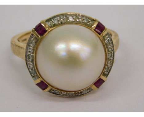 A 9ct gold pearl, ruby, and diamond dress ring, the central blister pearl, in a rub over setting with four baguette cut ruby 