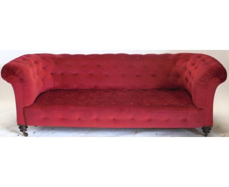 A Victorian walnut Chesterfield sofa, with red buttoned upholstery, 200cm wide. 