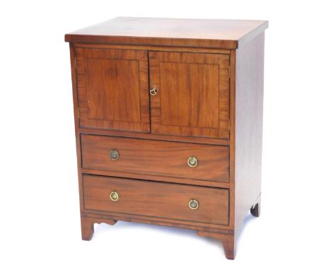 An early 20thC mahogany commode, with cupboard front above two drawers on ogee bracket feet, 81cm high, 63cm wide, 48cm deep.