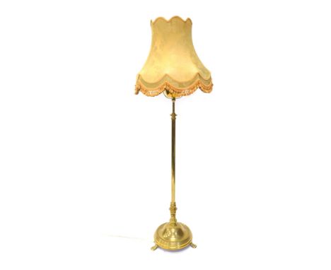 A brass telescopic standard lamp, with electrical feature and floral shade, 181cm high. WARNING! This lot contains untested o