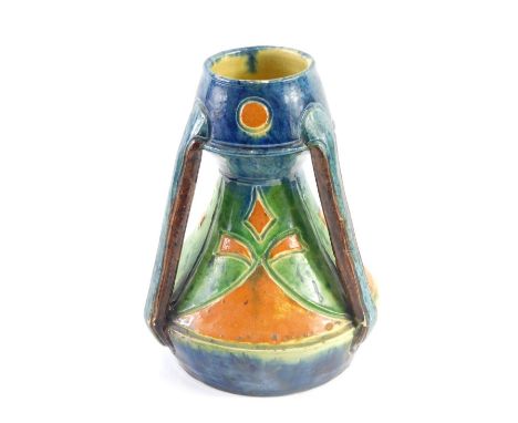 A Linthorpe style Art Nouveau pottery tyg, numbered 146, vibrantly decorated in orange, green, and blue, 21cm high.