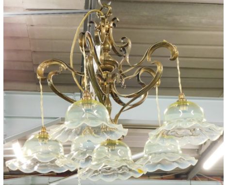A brass Art Nouveau design five branch chandelier, set with six vaseline glass shades, on an entwined baluster column, 47cm h