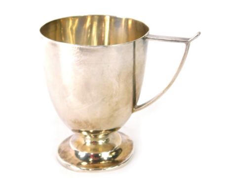 A George V silver christening cup, with angular wishbone shaped handle, and a domed foot, Sheffield 1926, 2.9oz, 8cm high. 