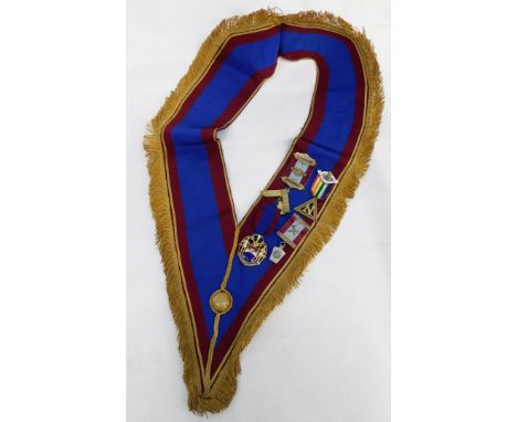 A Masonic sash, set with four jewels, silver gilt set square marked Presented to Wor Bro F Patman November 1935, a Heneage Ar