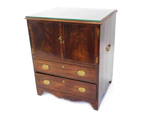 A George III mahogany commode, with cross banded top above double cupboards and two drawers on splayed feet with brass side c