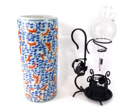 A Chinese pottery stick barrel, profusely decorated with fish and flowers, in orange and blue, 46cm high, 22cm diameter, and 