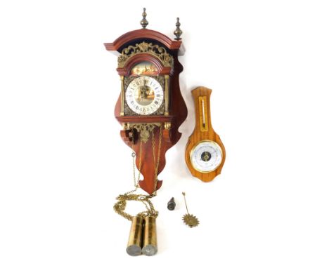 A hanging barometer and a Dutch Zaanse style clock, with Roman numeric dial, 51cm high. 