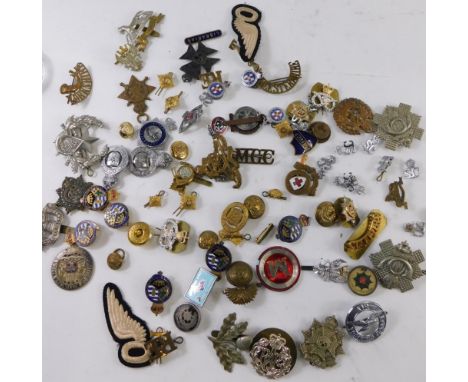 Various army cap badges, etc., a Ubique cannon cap badge, 4cm high, RAF, and various others, iron on wings, etc. (a quantity)