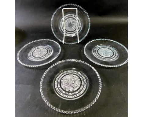 A set of four 20thC Lalique saucers, each with a bead border and centre, marked beneath R. Lalique, 17cm diameter. (4) 